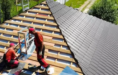 House with a new asphalt shingle roof and yellow siding